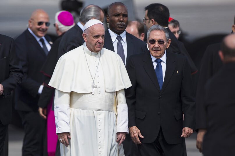 Pope Francis, left, walks next to Cuban President Raul Castro, at the Jose Marti airport in Havana, Cuba, Friday, Feb. 12, 2016. Pope Francis will meet for two hours with the head of the Russian Orthodox Church Patriarch Kirill during a brief stop en route to Mexico. (AP Photo/Desmond Boylan)