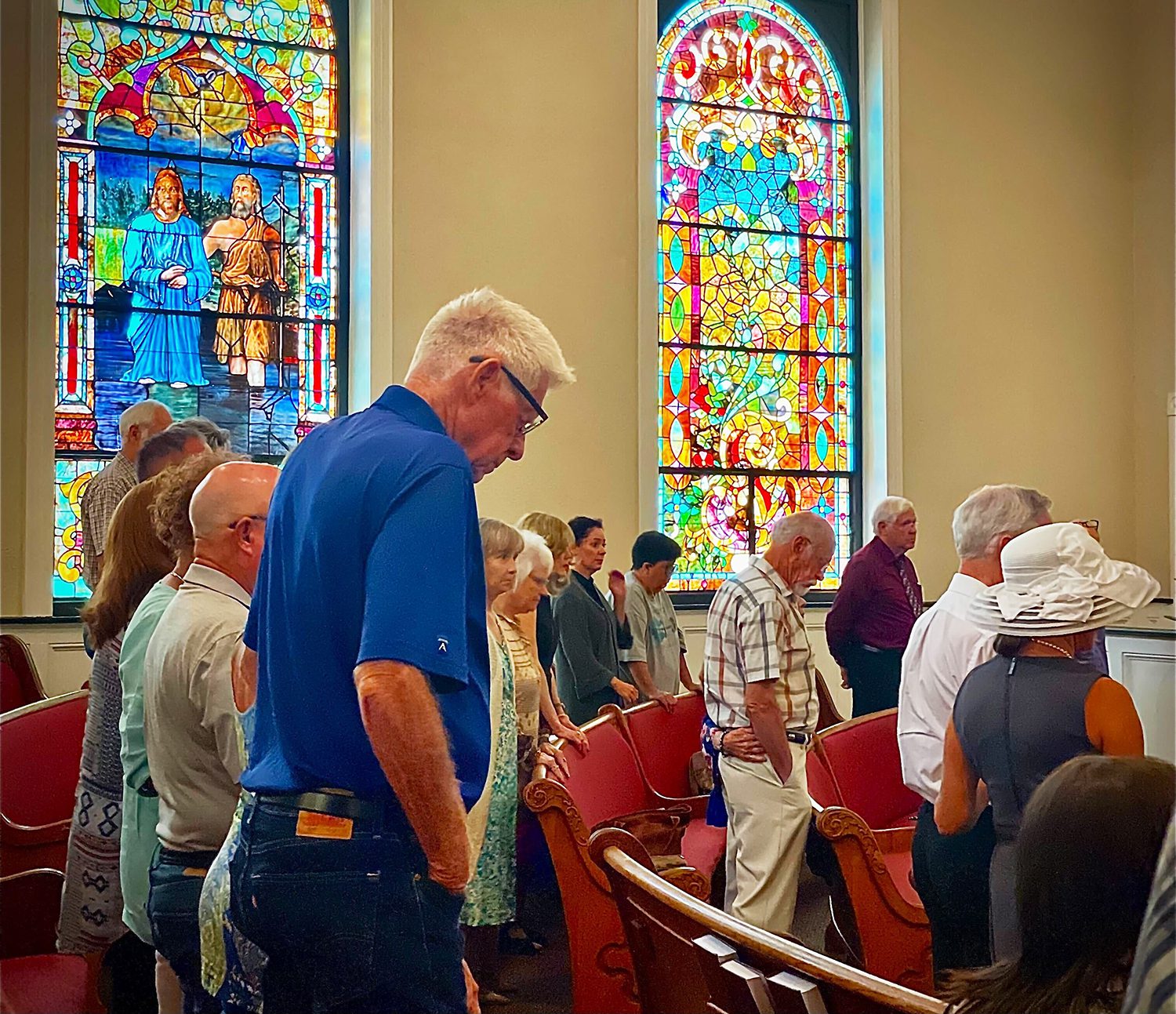 Members bow their heads in prayer during a service at First Baptist Church in Farmsville, Texas. RNS photo by Riley Farrell