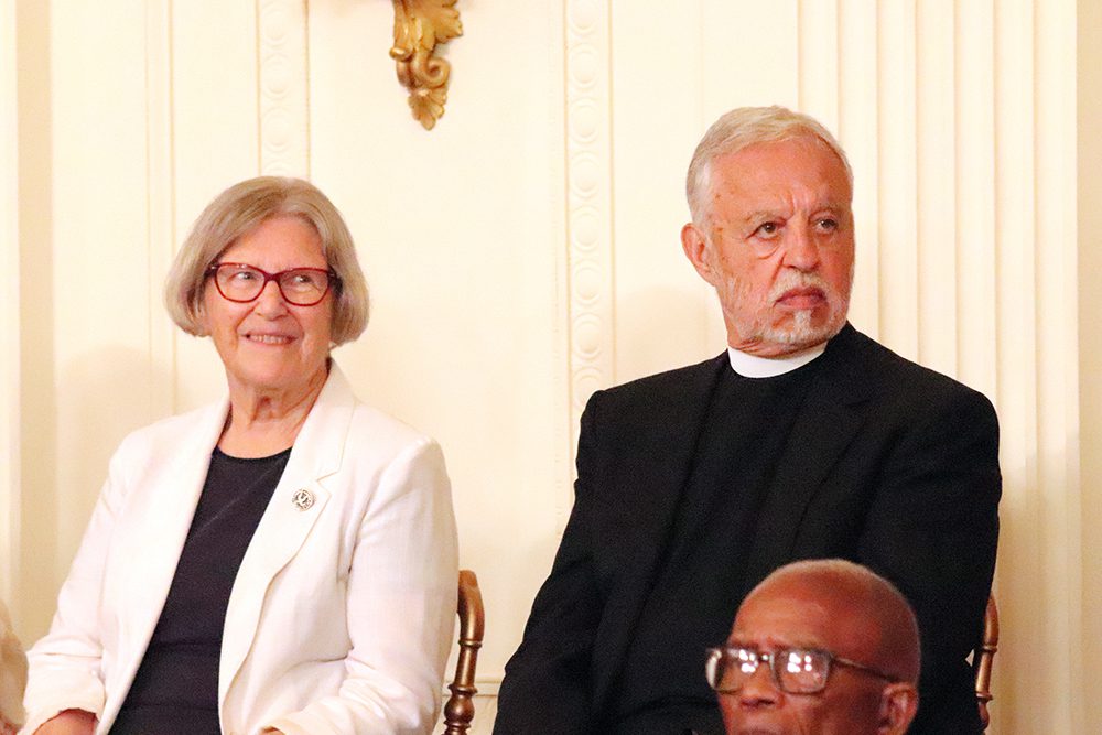 Sister Simone Campbell, left, and the Rev. Alexander Karloutsos listen to President Joe Biden before each received a Presidential Medal of Freedom at the White House in Washington, Thursday, July 7, 2022. RNS photo by Adelle M. Banks