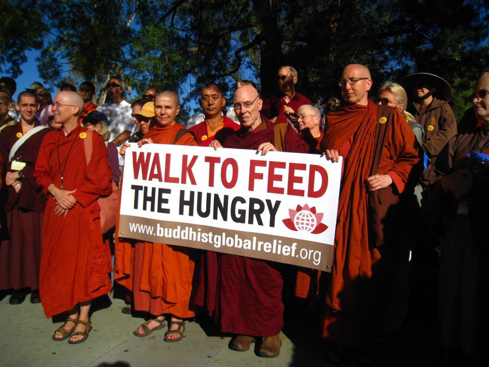 Bhikkhu Bodhi, center, holds a sign during a Buddhist Global Relief Walk To Feed The Hungry event. Photo courtesy BGR