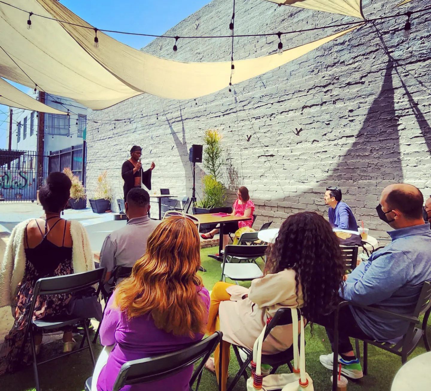 People attend an Inclusive Open Mic event hosted by Beloved Everybody at With Love Market & Cafe in Los Angeles. Photo courtesy of Beloved Everybody