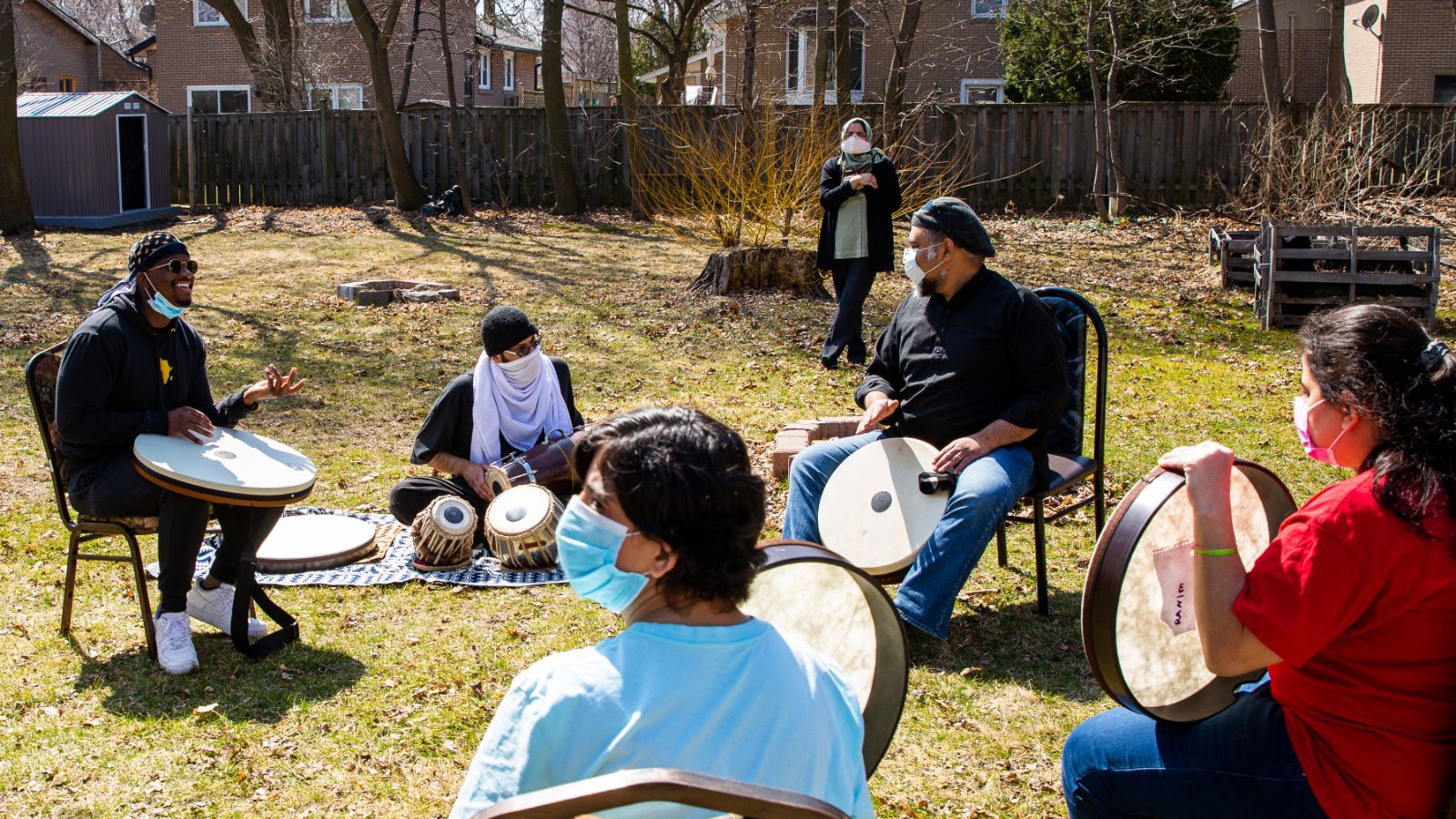 People participate in a drumming circle with DEEN Support Services.  Photo courtesy of DEEN Support Services