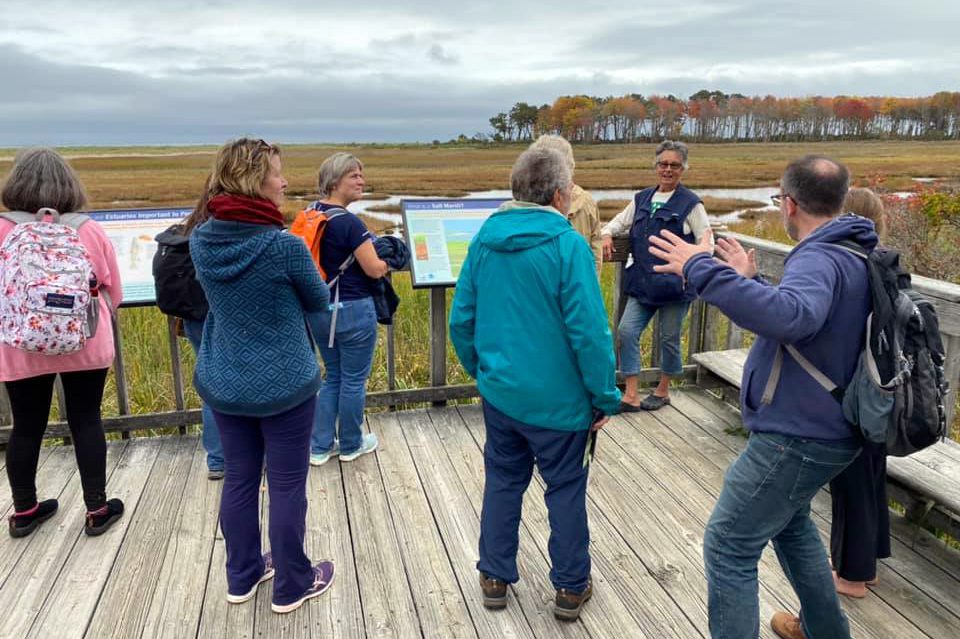 People attend a Wonder and Wander day retreat organized by The BTS Center at Wells Reserve in Wells, Maine, in autumn 2021. Maine Master Naturalist Linda Littlefield Grenfell, top right, led the excursion. Photo courtesy of The BTS Center