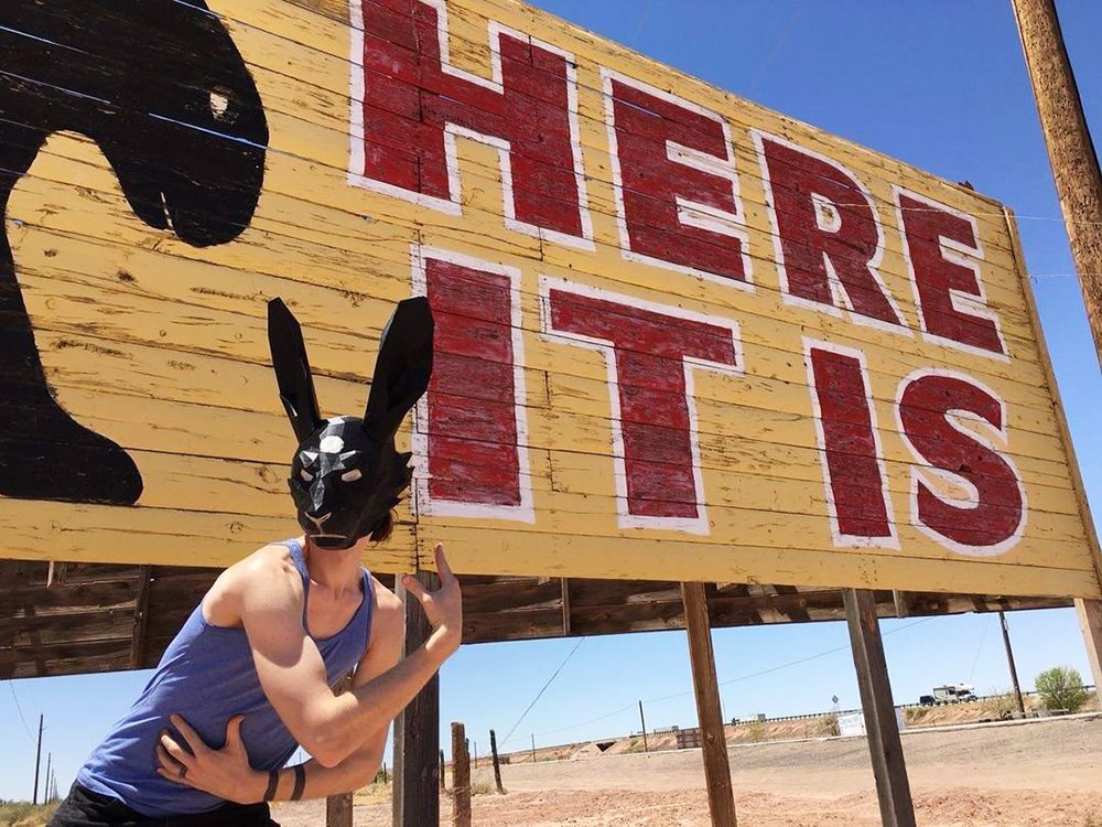 Artist Jonathan Duncan poses with a mask, engaging his fursona, Monkey Jonathan (MJ), which depicts Duncan in a "pure autobiographical meaning" near Joseph City, Arizona.  RNS photo by Riley Farrell