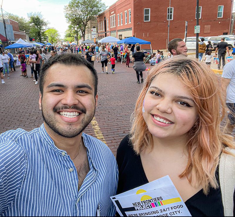 Alejandro Rangel-Lopez, left, and Angelica Plata hand out flyers about the New Frontiers Project during the Main Street Festival in Dodge City, Kansas, in June 2022. Photo courtesy of Rangel-Lopez