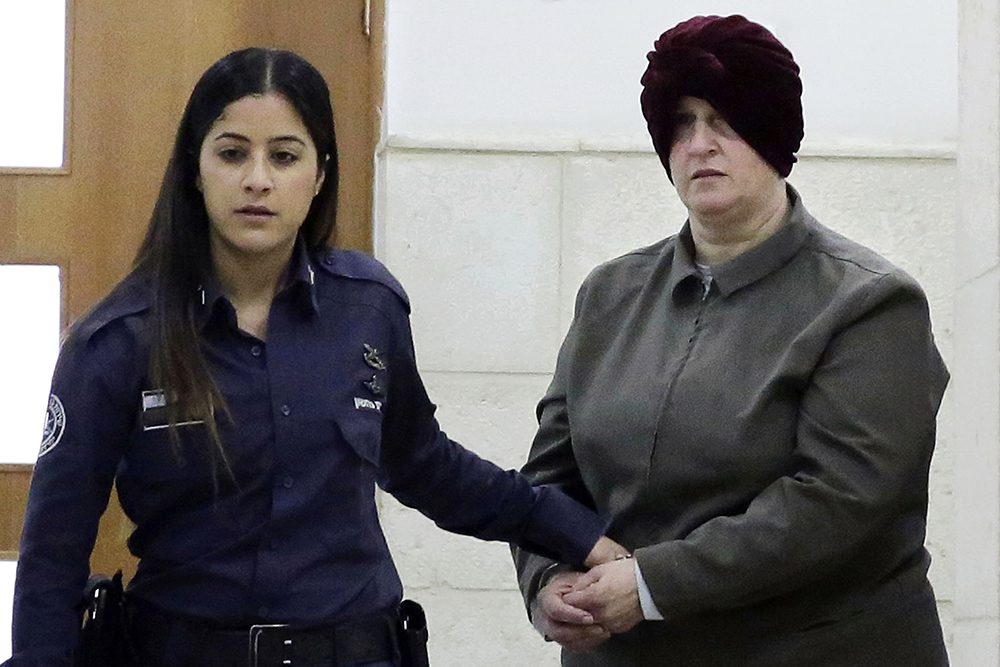 FILE - In this Feb. 27, 2018, file photo, Israeli-born Australian Malka Leifer, right, is brought to a courtroom in Jerusalem. Leifer, a former school principal extradited from Israel after a six-year legal battle appeared in an Australian court on Monday, Sept. 13, 2021, to hear evidence behind child sex abuse charges against her. (AP Photo/Mahmoud Illean, File)