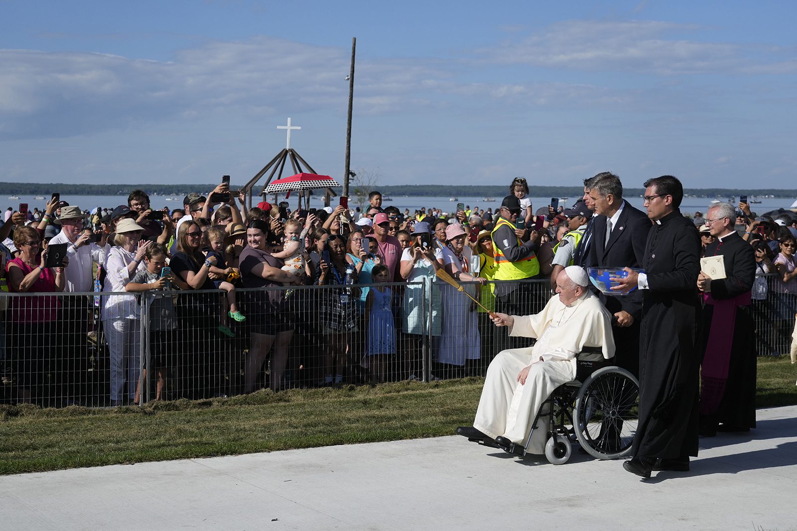 Pope Francis blesses faithfuls as he arrives at the Lac Ste. Anne pilgrimage site in Alberta, Canada, Tuesday, July 26, 2022. Pope Francis is on a second day of a "penitential" six-day visit to Canada to beg forgiveness from survivors of the country's residential schools, where Catholic missionaries contributed to the "cultural genocide" of generations of Indigenous children by trying to stamp out their languages, cultures and traditions. (AP Photo/Gregorio Borgia)