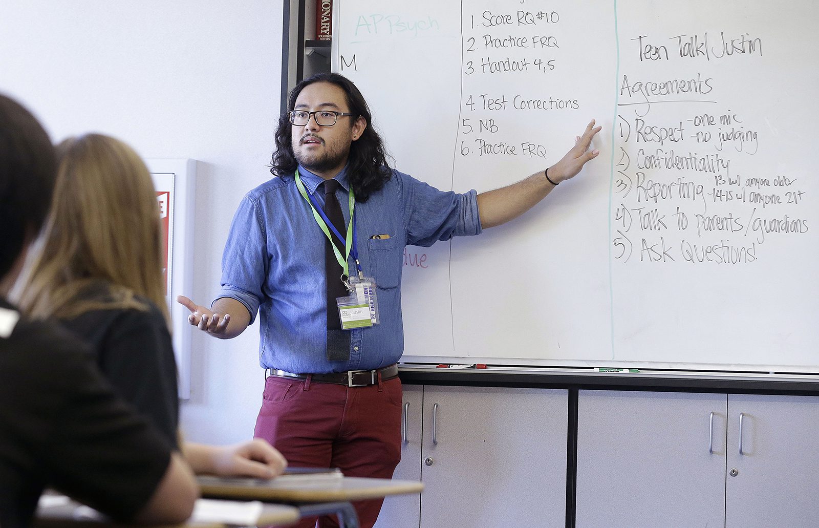In this Oct. 8, 2015 file photo, Justin Balido, peer health coordinator and senior health educator with Health Connected, speaks to a ninth-grade Teen Talk High School class at Carlmont High School in Belmont, Calif. Sex education in some American high schools is evolving beyond pregnancy and disease prevention to include lessons aimed at consent and curbing sexual assaults. (AP Photo/Jeff Chiu)