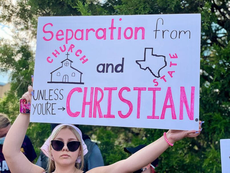 A demonstrator holds a sign during an abortion-rights protest in Denton, Texas, June 28, 2022, following the U.S. Supreme Court overturning the landmark abortion case Roe v. Wade. RNS photo by Riley Farrell