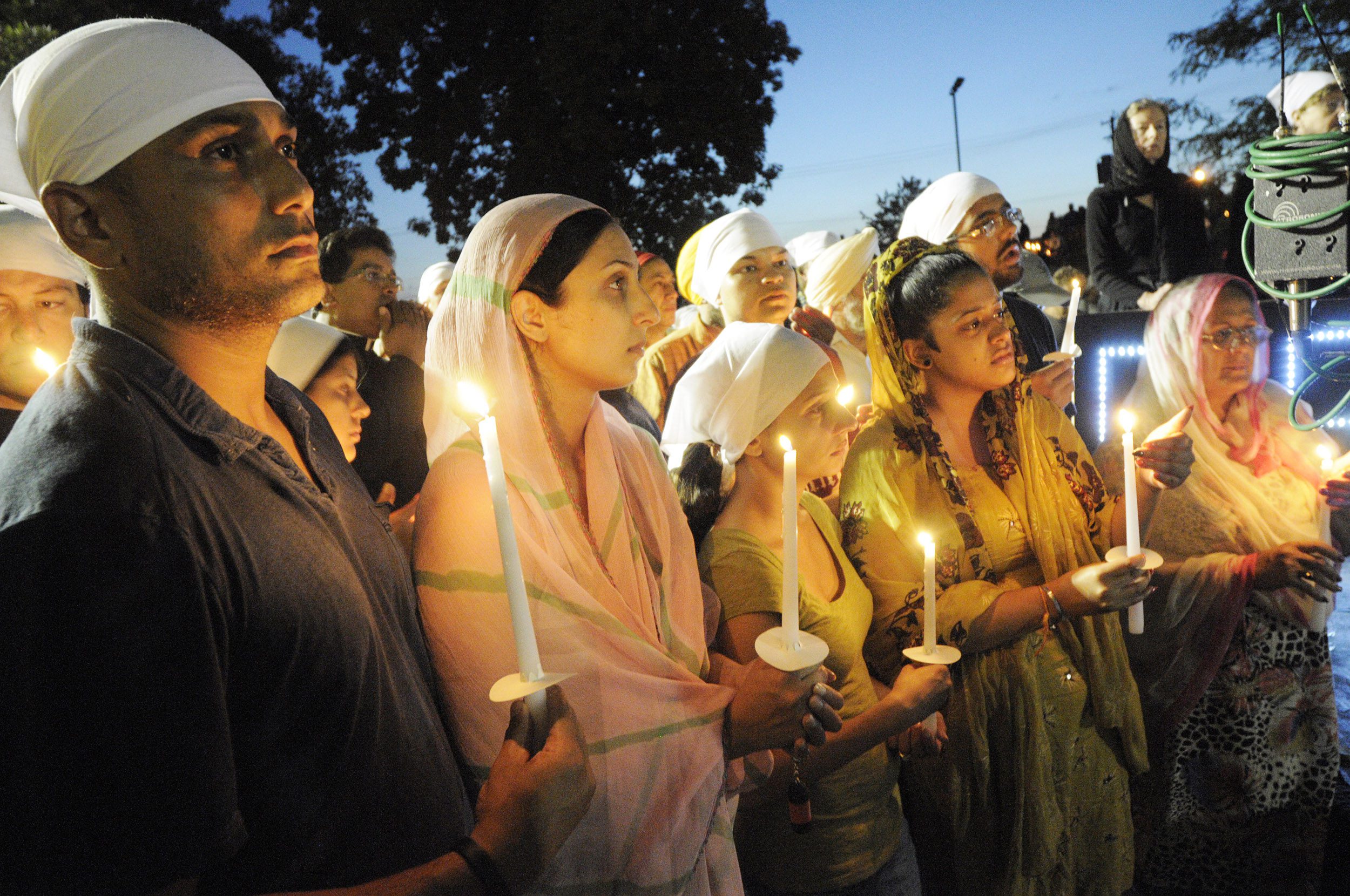Pardeep Kaleka, far left, his wife Jaspreet Kaleka and other family members at the Oak Creek vigil for victims of the Sikh Temple shootings. Pardeep's father Satwant, was killed in the shooting. Photo by Ernie Mastroianni photo, courtesy of Sikh Coalition