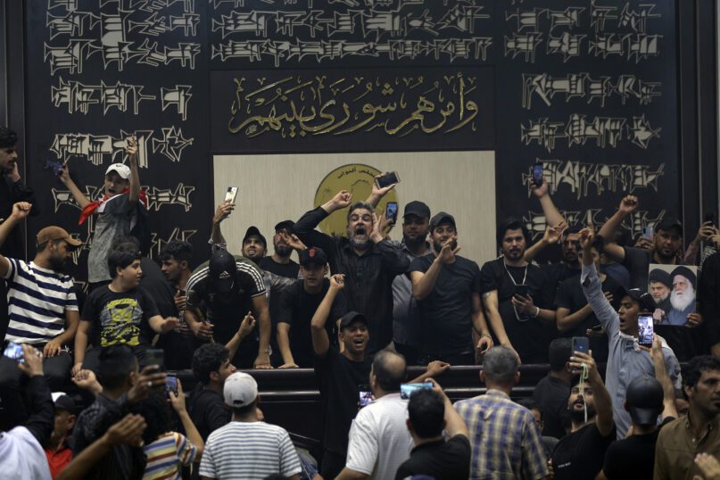 Iraqi protesters, mostly followers of Shiite cleric Muqtada al-Sadr, fill the parliament building in Baghdad, July 31, 2022. The political rivals of al-Sadr have declared their own counterprotest. The announcement on Monday stirred fear among Iraqis and caused security forces to erect concrete barriers leading to the heavily fortified Green Zone that houses the parliament building. (AP Photo/Anmar Khalil, File)