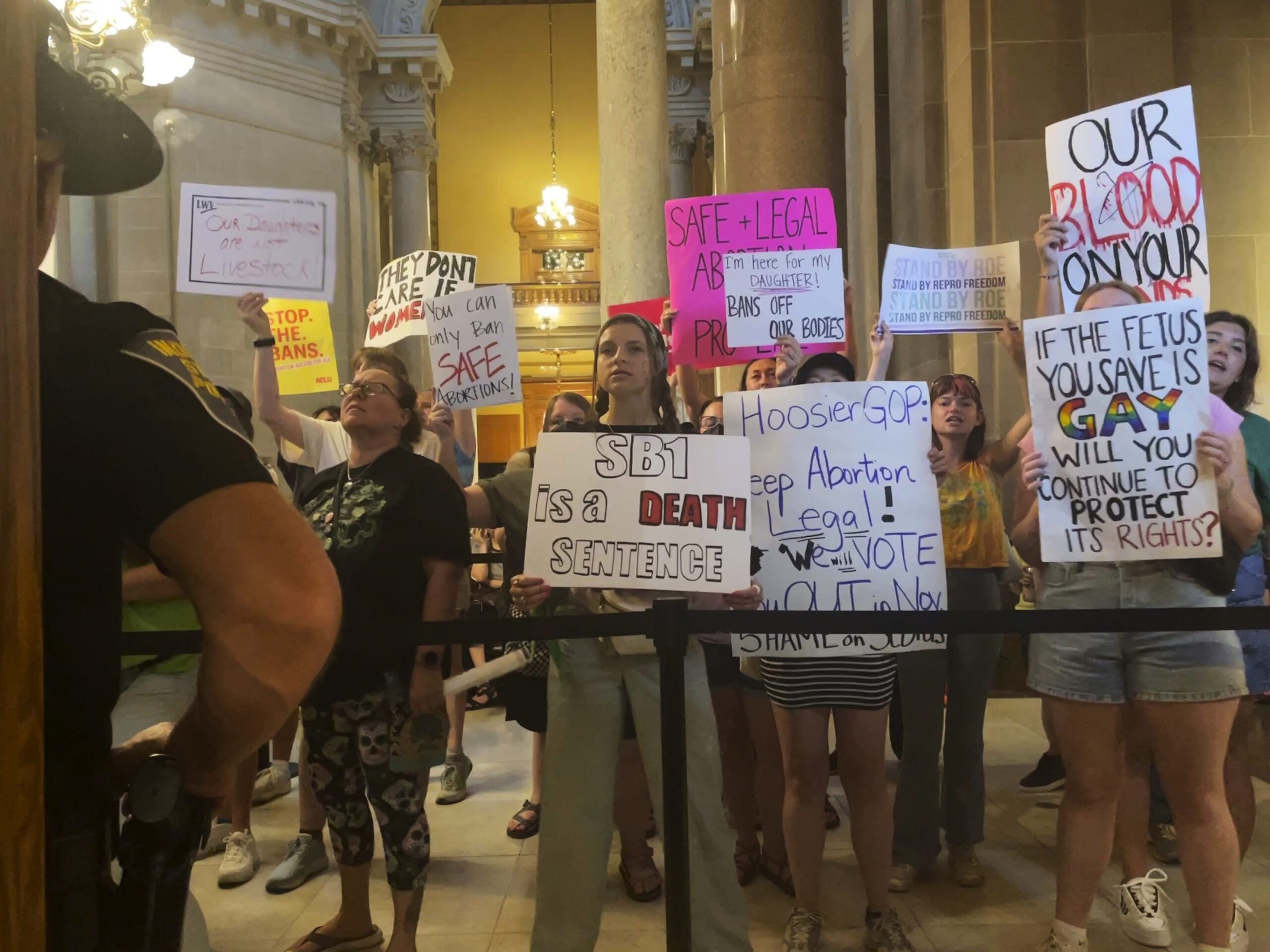 Abortion-rights protesters fill Indiana Statehouse corridors and demonstrate outside legislative chambers, Friday, Aug. 5, 2022, as lawmakers vote to concur on a near-total abortion ban, in Indianapolis. (AP Photo/Arleigh Rodgers)