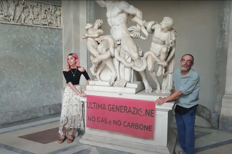 A video grab from a footage made available by environmental activists, shows two members of Ultima Generazione, or Last Generation in English, glued their hands on the Roman statue of Laocoön and His Sons, one of the masterpieces of the Vatican Museums collection, to protest against climate change, Thursday, Aug. 18, 2022. The activists displayed a banner reading, 
