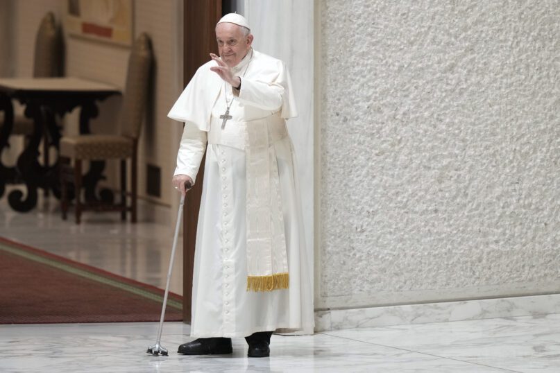 Pope Francis waves to faithful as he arrives in the Paul VI hall for his the weekly general audience at the Vatican, Wednesday, Aug. 10, 2022. (AP Photo/Andrew Medichini)