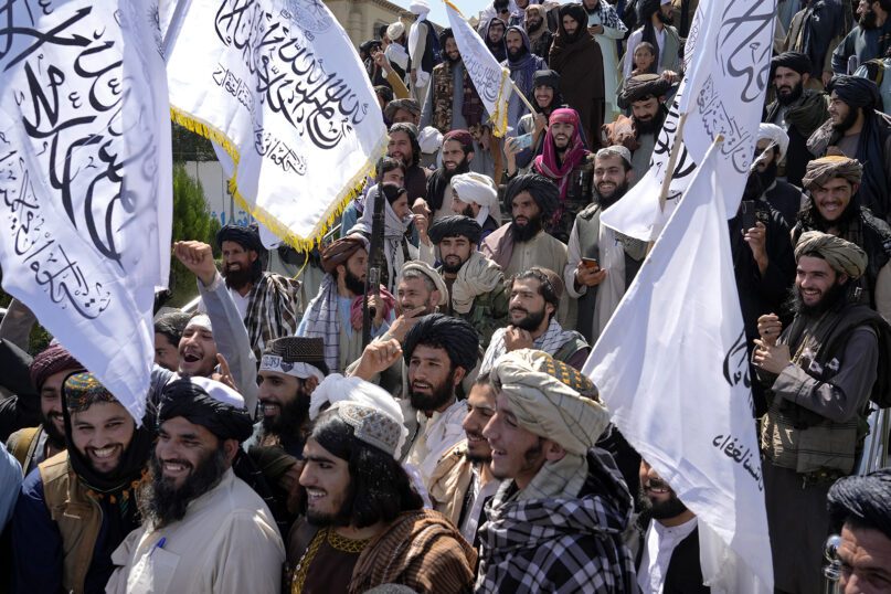 Taliban fighters celebrate the first anniversary of the withdrawal of U.S.-led troops from Afghanistan, in front of the U.S. Embassy in Kabul, Afghanistan, Aug. 31, 2022. (AP Photo/Ebrahim Noroozi)