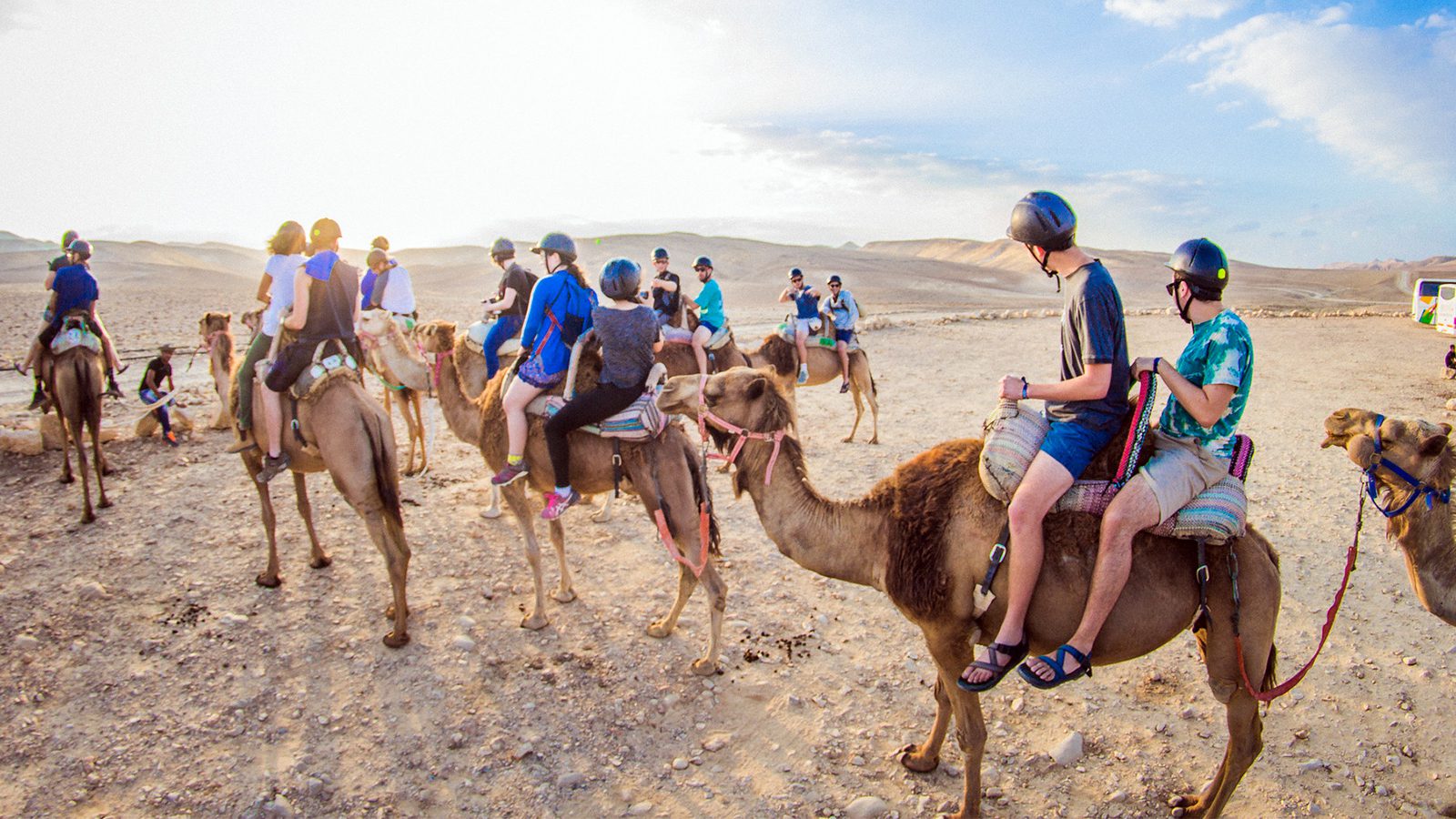 Birthright Israel participants ride camels during a trip in 2016. Photo by HRYMX/Flickr/Creative Commons
