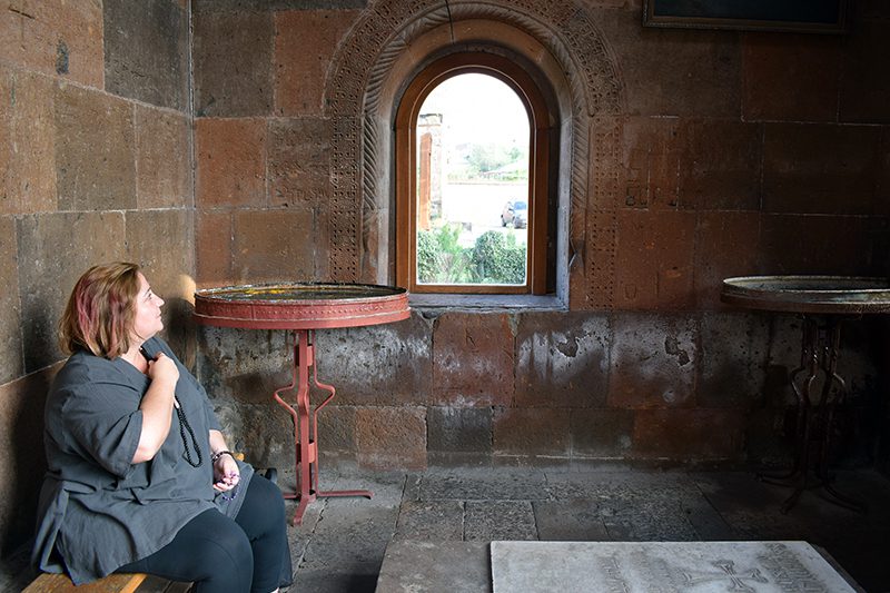 Human rights defender Lara Aharonian prays at Saint Shoghakat Church, the site where a group of unnamed nuns were martyred during Armenia’s conversion to Christianity, in the spiritual capital Echmiadzin, on July 1, 2022. Photo by Priyadarshini Sen