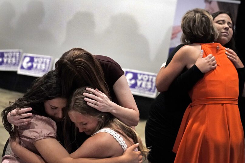 People hug during a Value Them Both watch party after a question involving a constitutional amendment removing abortion protections from the Kansas constitution failed, Aug. 2, 2022, in Overland Park, Kansas. Value Them Both was an anti-abortion group that wanted the amendment question to pass. (AP Photo/Charlie Riedel)