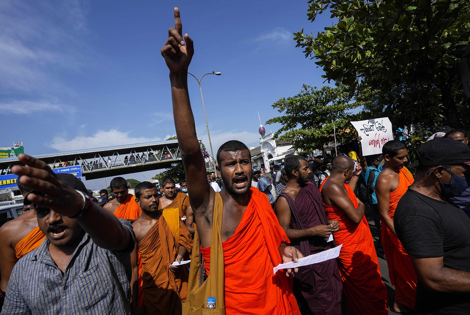 Buddhist monks shout slogans demanding acting president and prime minister Ranil Wickremesinghe resign in Colombo, Sri Lanka, Tuesday, July 19, 2022. (AP Photo/Eranga Jayawardena)
