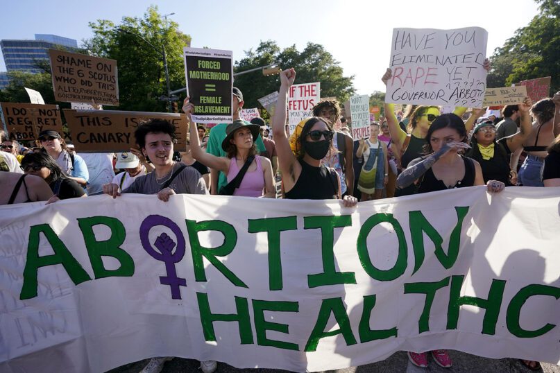 Demonstrators march and gather near the Texas state Capitol in Austin after the Supreme Court’s decision to overturn Roe v. Wade on June 24, 2022. A federal judge in Texas issued a ruling on Aug. 23, 2022, temporarily blocking the federal government from enforcing guidance against the state that requires hospitals to provide abortion services if the life of the mother is at risk. (AP Photo/Eric Gay, File)