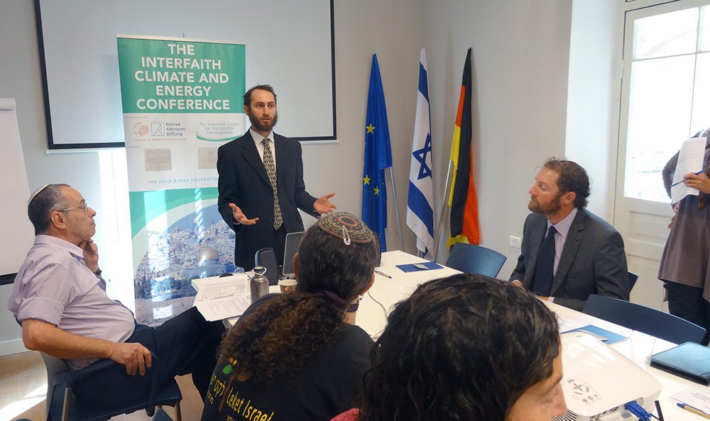Rabbi Yonatan Neril, standing, addresses an Interfaith Climate and Energy Conference. Photo by Mariona Bonsfills/Wikipedia/Creative Commons
