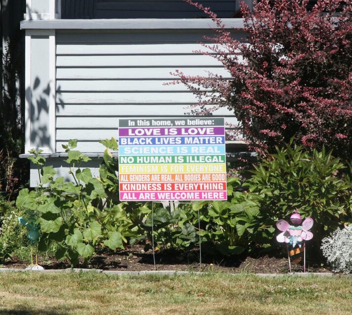A sign in a yard listing many virtues – an example of virtue signaling. (davelogan/iStock via Getty images)