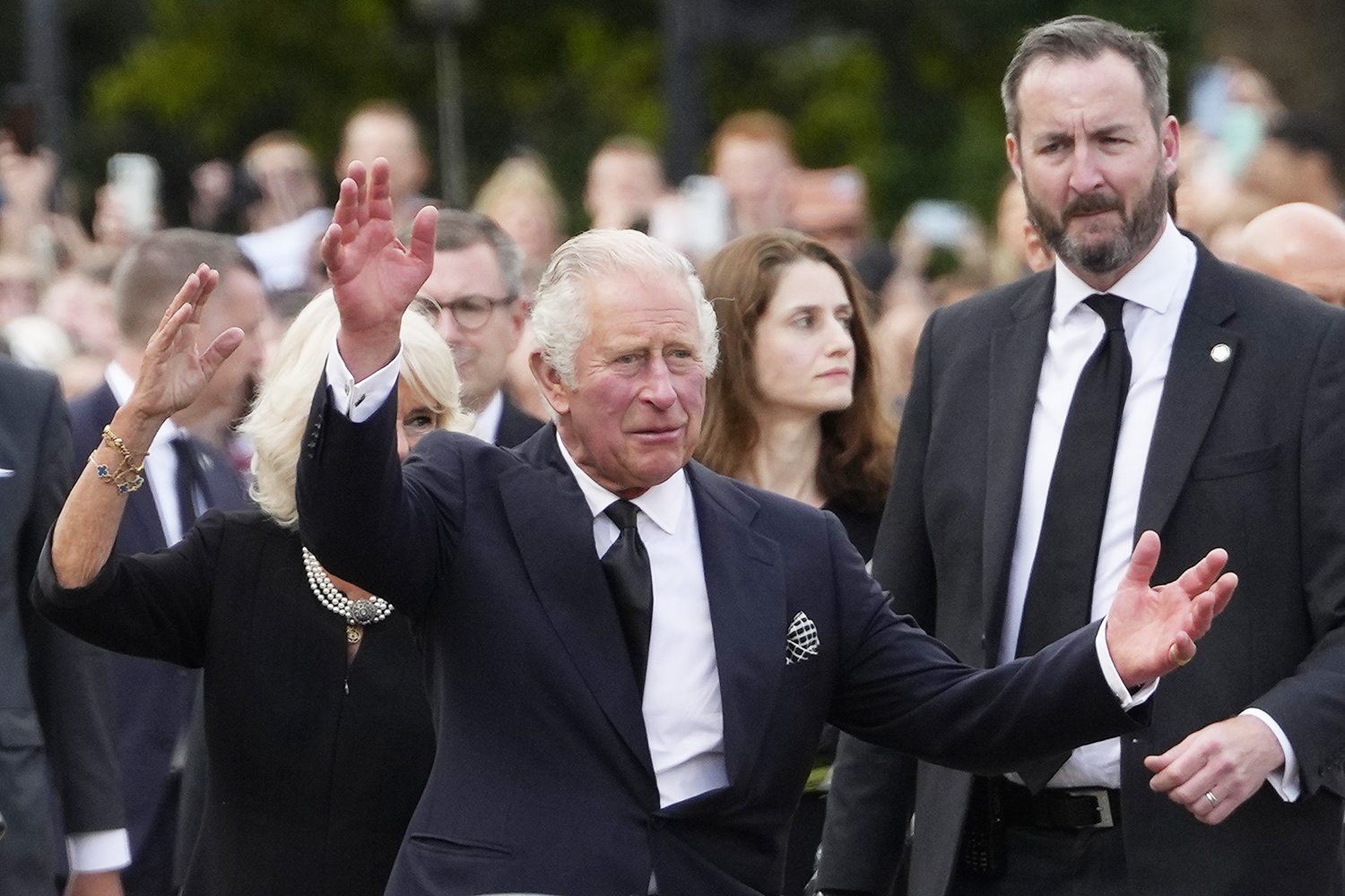 King Charles III and Camilla, the Queen Consort, wave as they arrive at Buckingham Palace in London, Friday, Sept. 9, 2022. Queen Elizabeth II, Britain's longest-reigning monarch and a rock of stability across much of a turbulent century, died Thursday Sept. 8, 2022, after 70 years on the throne. She was 96. (AP Photo/Kirsty Wigglesworth)