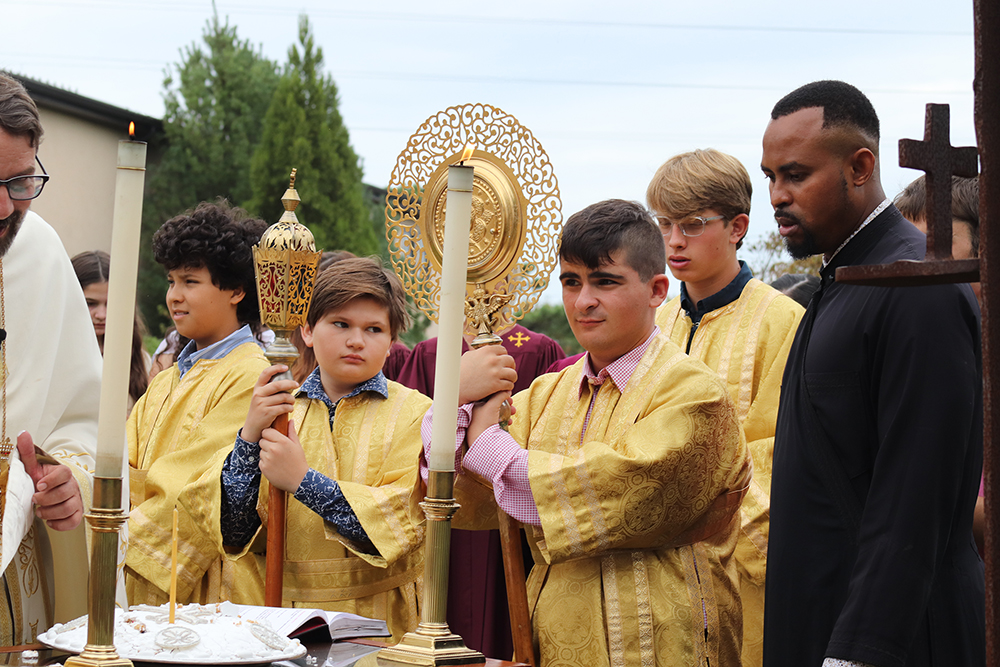 Dimitri Donus, second from right, serves as an acolyte during a service at Dormition of the Virgin Mary Greek Orthodox Church of the Hamptons in Southampton, New York, on Sept. 11, 2022. RNS photo by Adelle M. Banks