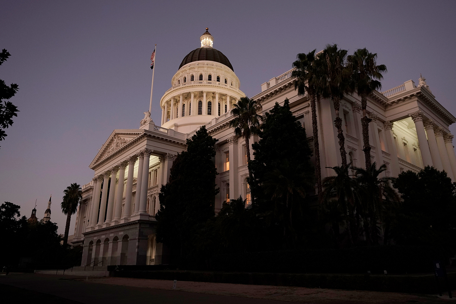 The lights of the state Capitol glow into the night in Sacramento, Calif., Wednesday, Aug. 31, 2022. (AP Photo/Rich Pedroncelli)