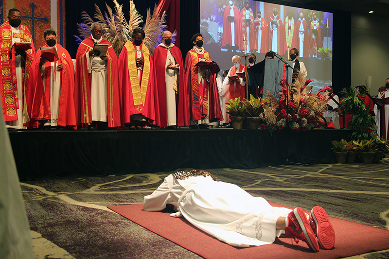 Bishop Paula Clark prostrates herself during her ordination service, on Sept. 17, 2022, at the Westin Chicago Lombard in suburban Lombard, Illinois. RNS photo by Emily McFarlan Miller