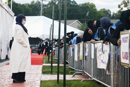 Dhiya Bakr, national president of the Women’s Auxiliary of the Ahmadiyya Muslim Community USA, speaks to the crowd waiting for Mirza Masroor Ahmad, the spiritual leader of the Ahmadiyya Muslim Community, to arrive Sept. 26, 2022, outside Fath-e-Azeem Mosque in Zion, Illinois. RNS photo by Emily McFarlan Miller