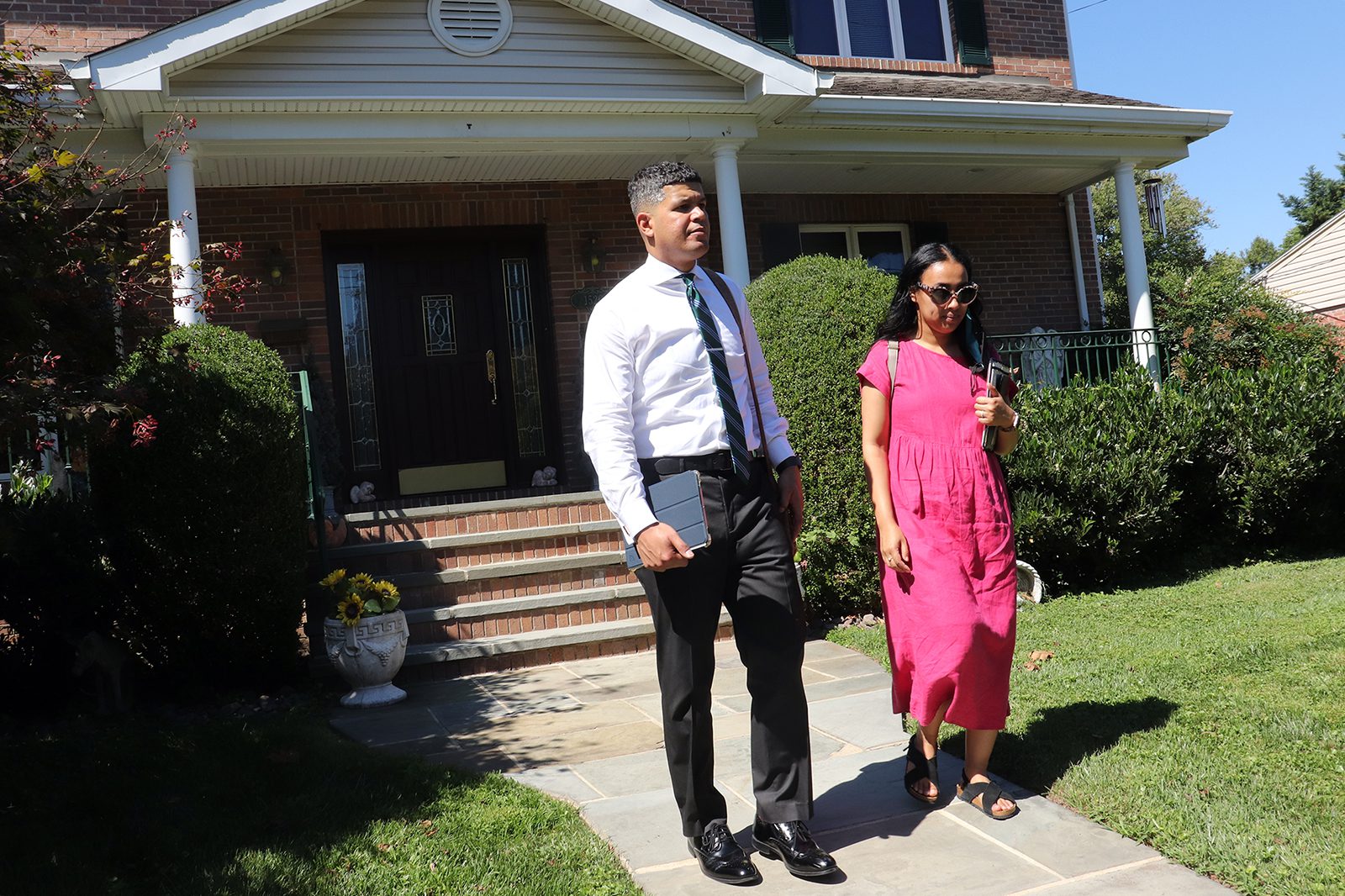 Chris and Aisha Sees, of Takoma Park, Maryland, leave a home while door knocking in Silver Spring on Thursday, Sept. 1, 2022. Jehovah’s Witnesses returned to the traditional practice of door knocking after a lengthy pause due to the pandemic. RNS photo by Adelle M. Banks