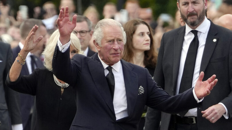 King Charles III and Camilla, the queen consort, wave as they arrive at Buckingham Palace in London, Friday, Sept. 9, 2022. Queen Elizabeth II, Britain's longest-reigning monarch and a rock of stability across much of a turbulent century, died Thursday Sept. 8, 2022, after 70 years on the throne. (AP Photo/Kirsty Wigglesworth)