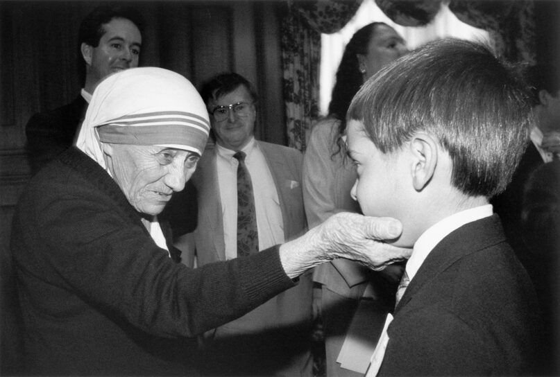 Mother Teresa interacts with a child in an undated photo from 