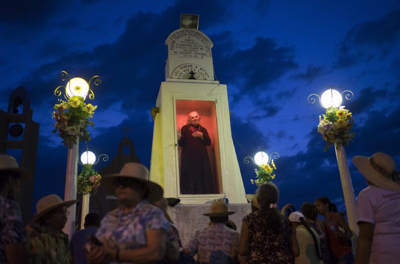 In this Oct. 30, 2015, photo, pilgrims pray and pay tribute at a statue of Padre Cicero, or Padim Ciço, at the public square in Juazeiro do Norte, Brazil. The Rev. Cicero Romao Batista was born in 1844 and died at age 90 in this arid, impoverished part of northeast Brazil. His followers say that during a Mass celebrated by the priest in 1889, a woman receiving Communion declared that the Communion host had turned to blood in her mouth. People called it a miracle, but the Vatican was displeased and suspended him. (AP Photo/Leo Correa)
