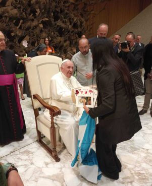 The Rev. Andrea Conocchia, center, introduces members of the Torvaianica transgender community to Pope Francis on Aug. 11, 2022, during the pope’s general audience at the Vatican. Photo courtesy of Andrea Conocchia