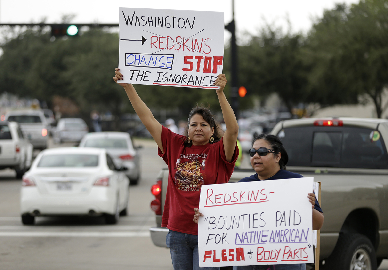 Yolonda Blue Horse, left, and Diana Parton protest with others before an NFL football game between the Dallas Cowboys and Washington Redskins, Sunday, October 13, 2013, in Arlington, Texas. (AP Photo/LM Otero)