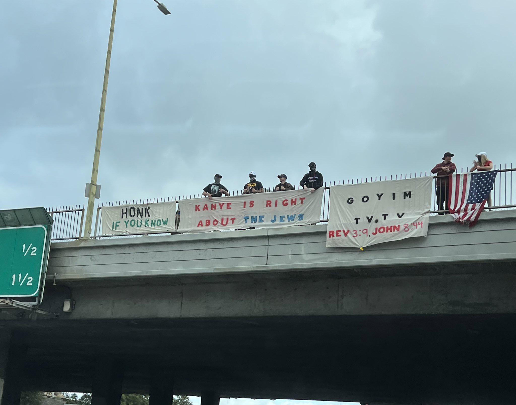 "Goyim Defense League" members hang banners over a highway in Los Angeles. Photo via Twitter/@StopAntisemites
