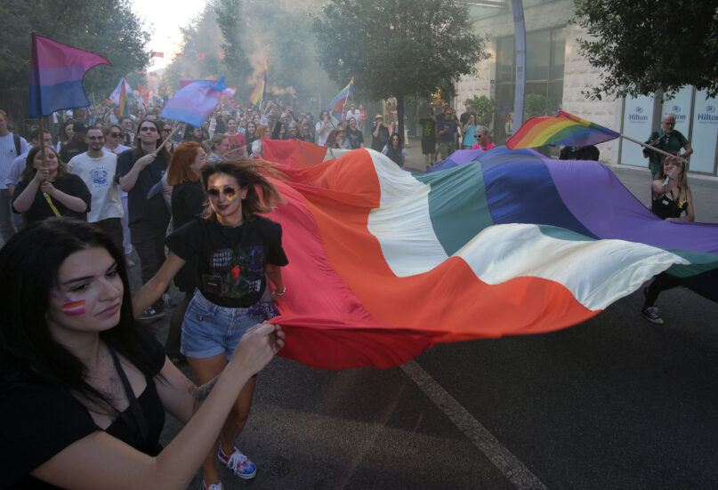 Participants take part in a LGBTQ pride march in Podgorica, Montenegro, Saturday, Oct. 8, 2022. Several hundred people joined an LGBTQ pride march in Montenegro, held amid strong opposition from the influential Serbian Orthodox Church in the small conservative Balkan country. (AP Photo/Risto Bozovic)