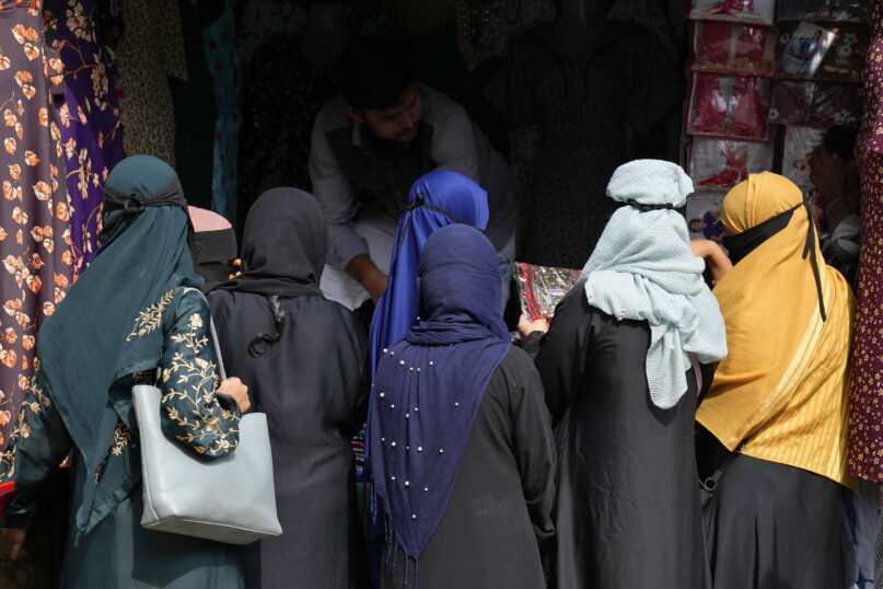 A group of veiled Muslim women shop for clothes in Bengaluru, India, Thursday, Oct. 13, 2022. Two judges on India's top court on Thursday differed over a ban on the wearing of the hijab, a headscarf used by Muslim women, in educational institutions and referred the sensitive issue to a larger bench of three or more judges to settle. (AP Photo/Aijaz Rahi)