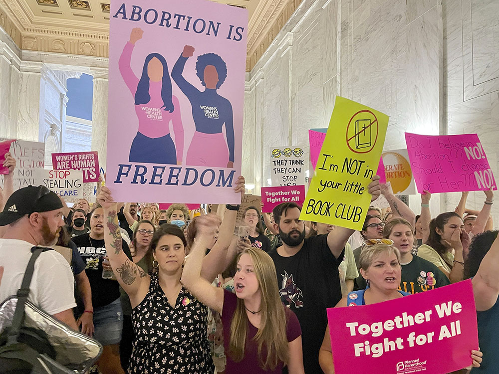 FILE - Abortion rights protesters chant outside of the West Virginia Senate chambers prior to a vote on an abortion bill, July 29, 2022, in Charleston, W.Va. (AP Photo/John Raby)