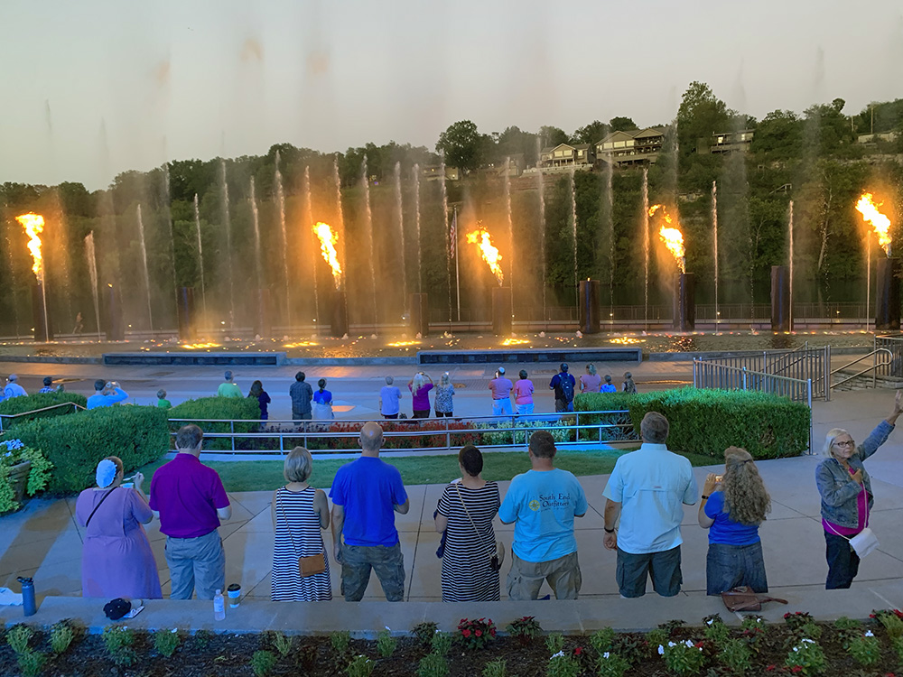 People stand for the national anthem during a water and fire show held at the Branson Landing on Aug. 25, 2022, in Branson, Mo. RNS photo by Kit Doyle