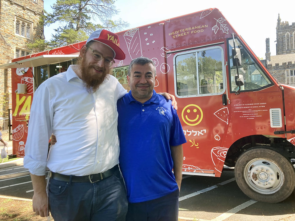 The Yalla food truck at Duke University offers kosher and halal food. The truck is supported by Rabbi Nossen Fellig of Chabad, left, and Abdullah Antepli, associate professor for the practice of interfaith relations. RNS photo by Yonat Shimron