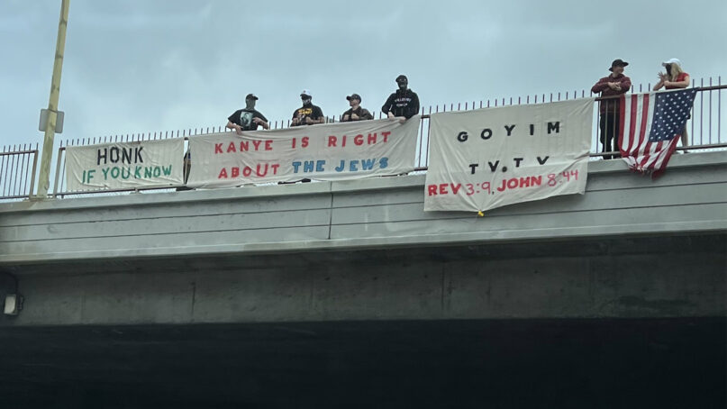 Antisemitic “Goyim Defense League” members hang banners over a highway recently in Los Angeles. Photo via Twitter/@StopAntisemites
