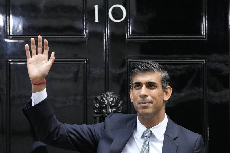 New British Prime Minister Rishi Sunak waves after arriving at Downing Street in London, Oct. 25, 2022, after returning from Buckingham Palace, where he was formally appointed to the post by Britain’s King Charles III. (AP Photo/Frank Augstein)