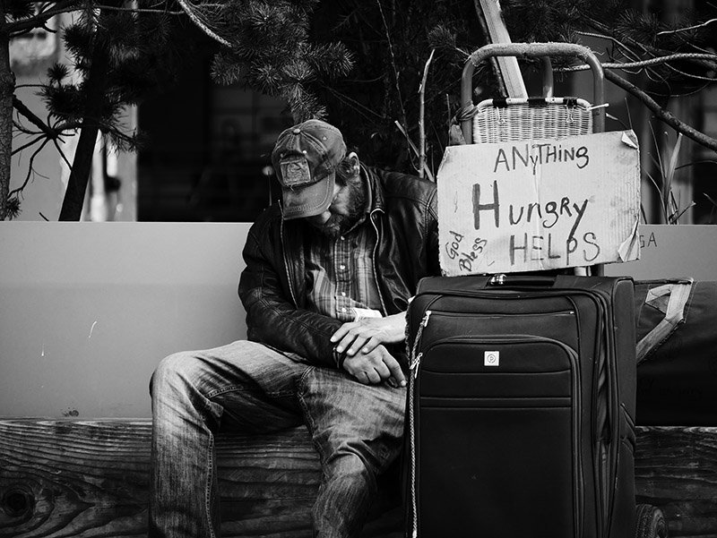 An unhoused man in Seattle. Photo by Steve Knutson/Unsplash/Creative Commons