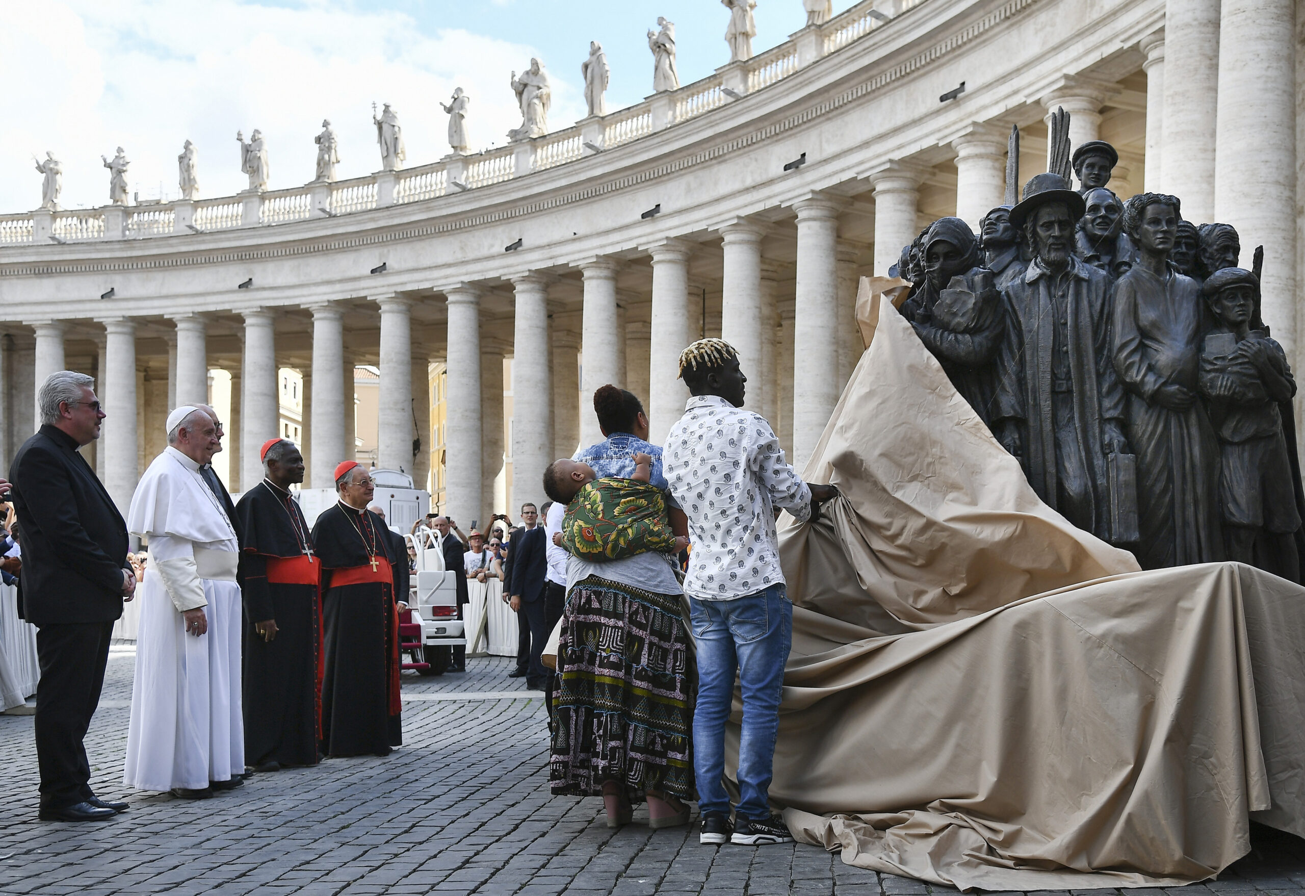 Pope Francis, left, watches the unveiling of the new sculpture "Angels Unawares" on the occasion of the Migrant and Refugee World Day, in St. Peter's Square, at the Vatican, on Sept. 29, 2019. (Vincenzo Pinto/Pool Photo via AP)