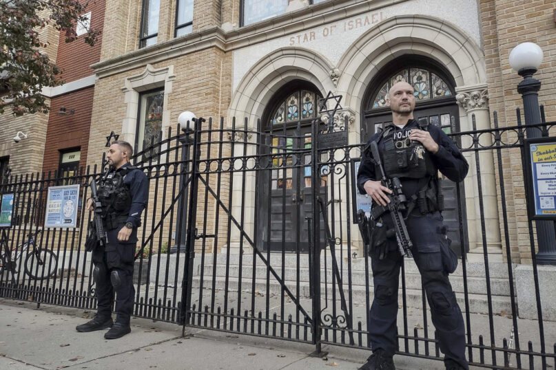 Hoboken Police officers stand watch outside the United Synagogue of Hoboken, Thursday, Nov. 3, 2022, in Hoboken, N.J. The FBI says it has received credible information about a threat to synagogues in New Jersey. The FBI's Newark office released a statement Thursday afternoon that characterizes it as a broad threat. The statement urged synagogues to 