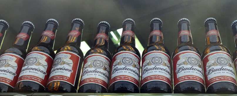 FILE - Bottles of Budweiser beer are on display in a shop window in London on Oct. 13, 2015. World Cup organizers reportedly have made another late change in alcohol policy only two days before games start in Qatar by banning beer sales at the eight soccer stadiums in and around Doha. Media reports say Qatari authorities are pressing FIFA to ban all sales of long-time World Cup beer sponsor Budweiser at the eight venues. (AP Photo/Kirsty Wigglesworth, File)