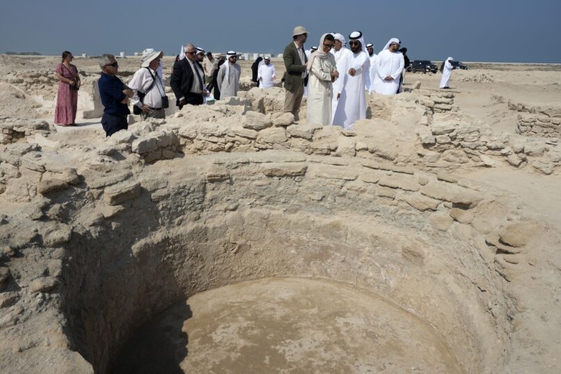 Sheikh Majid bin Saud Al Mualla, chairman of the Umm Al Quwain Department of Tourism and Archaeology, front right, explains to Noura Al Kaabi, UAE Minister of Culture and Youth, during a visit of the ancient Christian monastery on Siniyah Island in Umm al-Quwain, United Arab Emirates, Thursday, Nov. 3, 2022. The monastery possibly dating as far back as the years before Islam rose across the Arabian Peninsula has been discovered on an island off the coast of the UAE officials announced Thursday, Nov. 3, 2022. (AP Photo/Kamran Jebreili)
